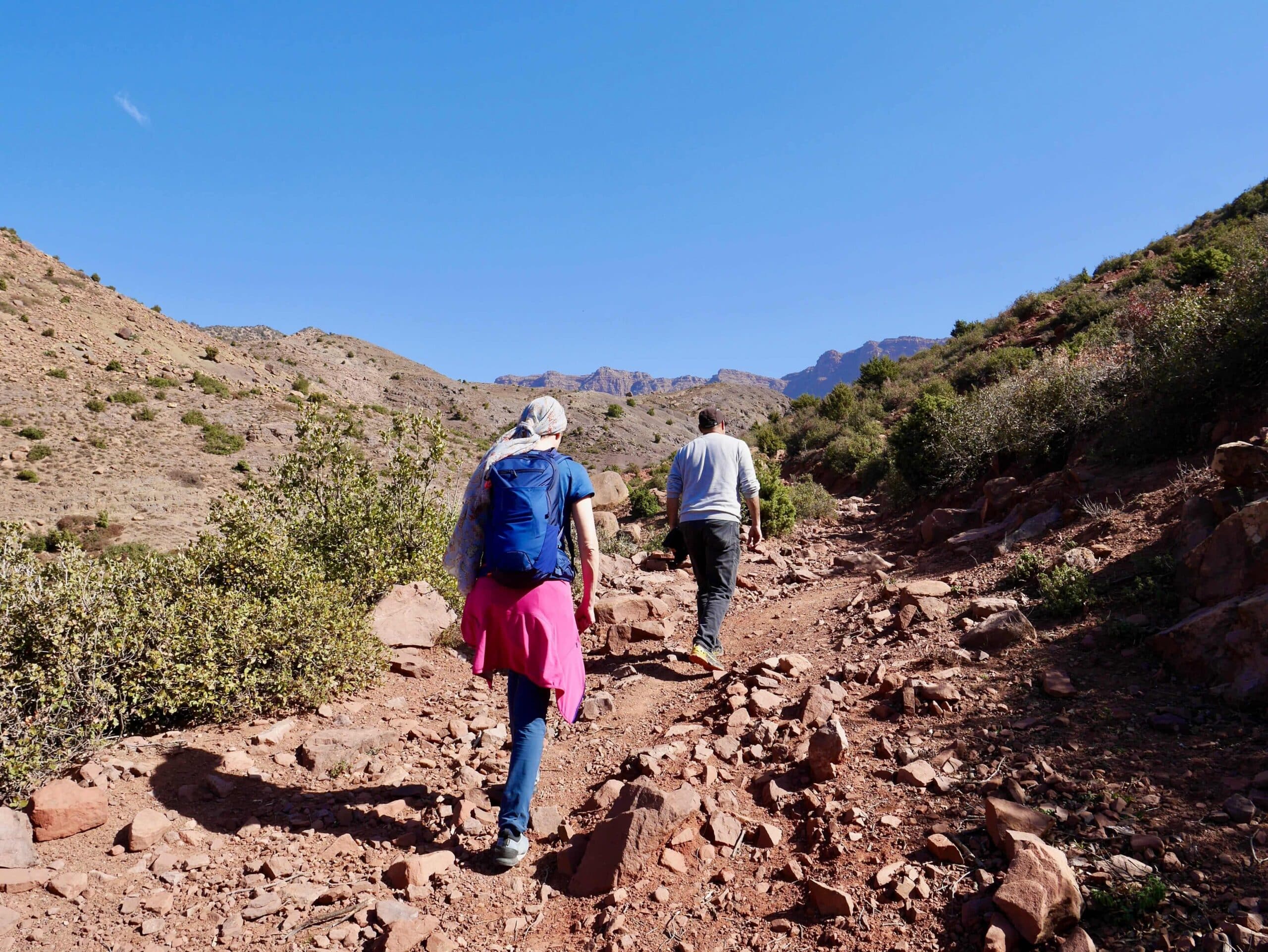 A couple hiking through the Atlas Mountains on their honeymoon in Morocco.