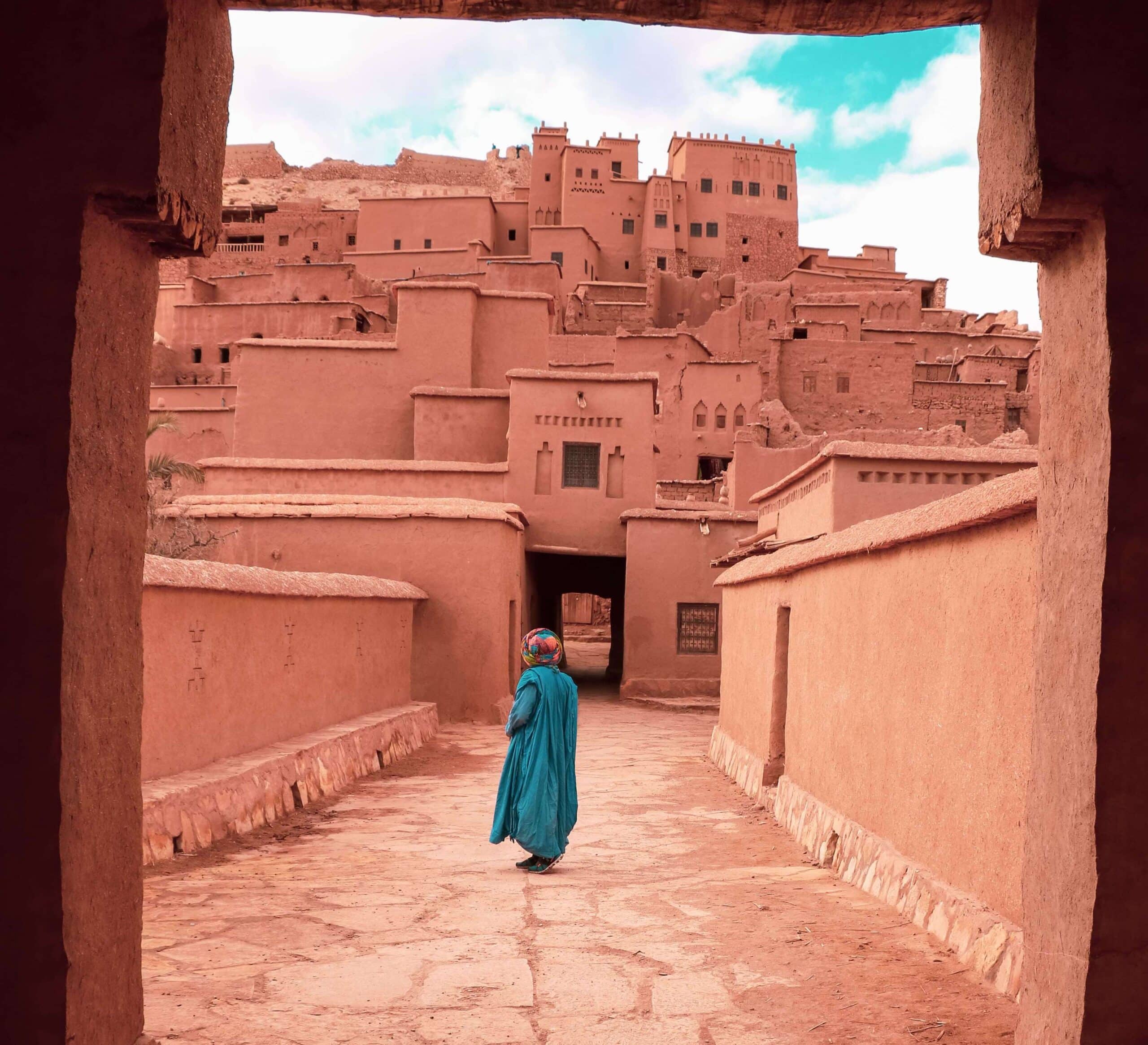 Man standing next to ancient buildings on a Morocco private tour.